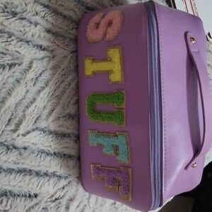 Purple make up bag with the word(Stuff) written on it